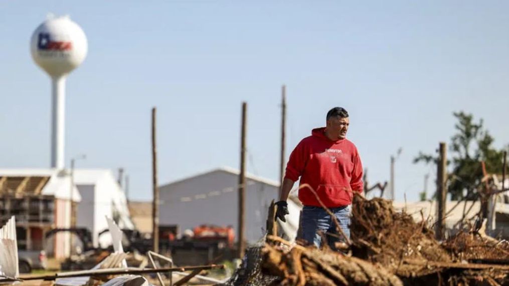 Adrian Herrera stands in debris of storage units that were damaged by Thursday's tornado in Perryton, Texas, Friday, June, 16, 2023. Cleanup efforts continued Friday after severe storms — including some that produced tornadoes — tore across a swath of Southern states, killing at least five people as they destroyed hundreds of homes, tossed vehicles into buildings and left hundreds of thousands without electricity. (AP Photo/David Erickson)