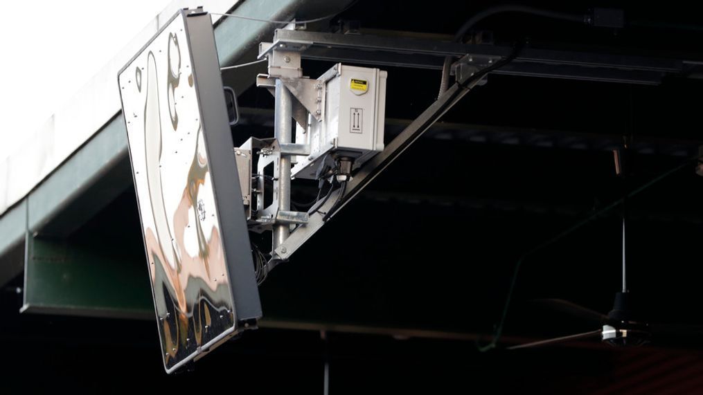 FILE - A radar device is seen on the roof behind home plate at PeoplesBank Park during the third inning of an Atlantic League All-Star minor league baseball game in York, Pa. Baseball's top minor leagues are switching to a challenge system full-time for their test of robot umpires. Major League Baseball has been experimenting with the automated ball-strike system in the minor leagues since 2019. (AP Photo/Julio Cortez, File)