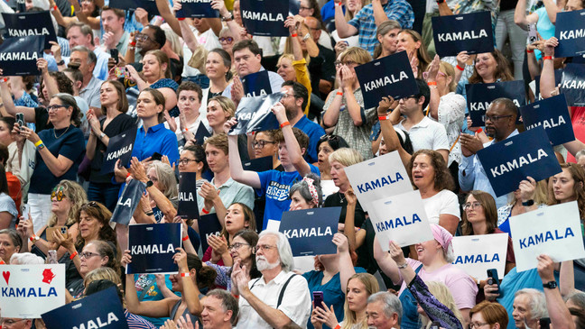 FILE - Supports hold up signs in support of Vice President Kamala Harris at an event, July 23, 2024, in West Allis, Wis. Voters, especially those who lean left, are expressing a renewed interest in the campaign and eager to see Harris take on the Democratic Party mantle in place of President Joe Biden. Harrisâ campaign is trying to capitalize on a jolt of fundraising, volunteer interest and media attention after Democrats spent three weeks following Bidenâs debate debacle wondering whether the octogenarian president would stand down or continue his campaign  despite dwindling support. (AP Photo/Kayla Wolf, File)